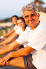 Wall Mural - middle aged man stretching before exercise