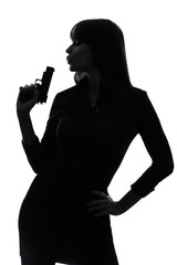 Wall Mural - sexy detective  woman holding aiming  gun silhouette