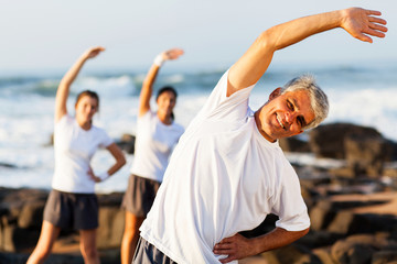 Wall Mural - mid age man exercising at the beach