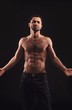 © Jacob Lund - Shirtless Man on Dark Background Gesturing