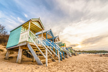 Colorful Beach Huts At Sunset