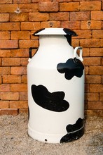 A Large Multi Color Metal Milk Container