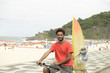 © mangostock - Surfer African descendant bicycle Ipanema Beach Rio de Janeiro