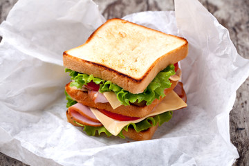 Canvas Print - Sandwich with bacon and vegetables on wooden table