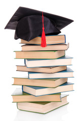 Poster - Grad hat with books isolated on white