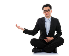 Wall Mural - Asian business man showing blank space sit on floor