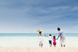 © Creativa Images - Happy family at white sand beach, Australia