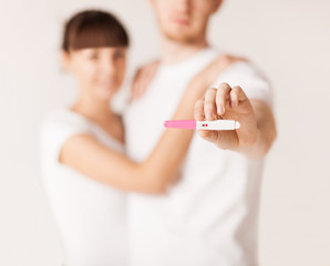 Poster - woman and man hands with pregnancy test