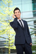 © mimagephotos - Happy businessman talking on mobile phone outdoors