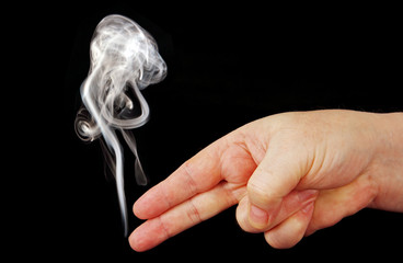 smoke from the fingers of a hand depicting weapons.