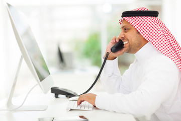 Wall Mural - arabian businessman answering telephone