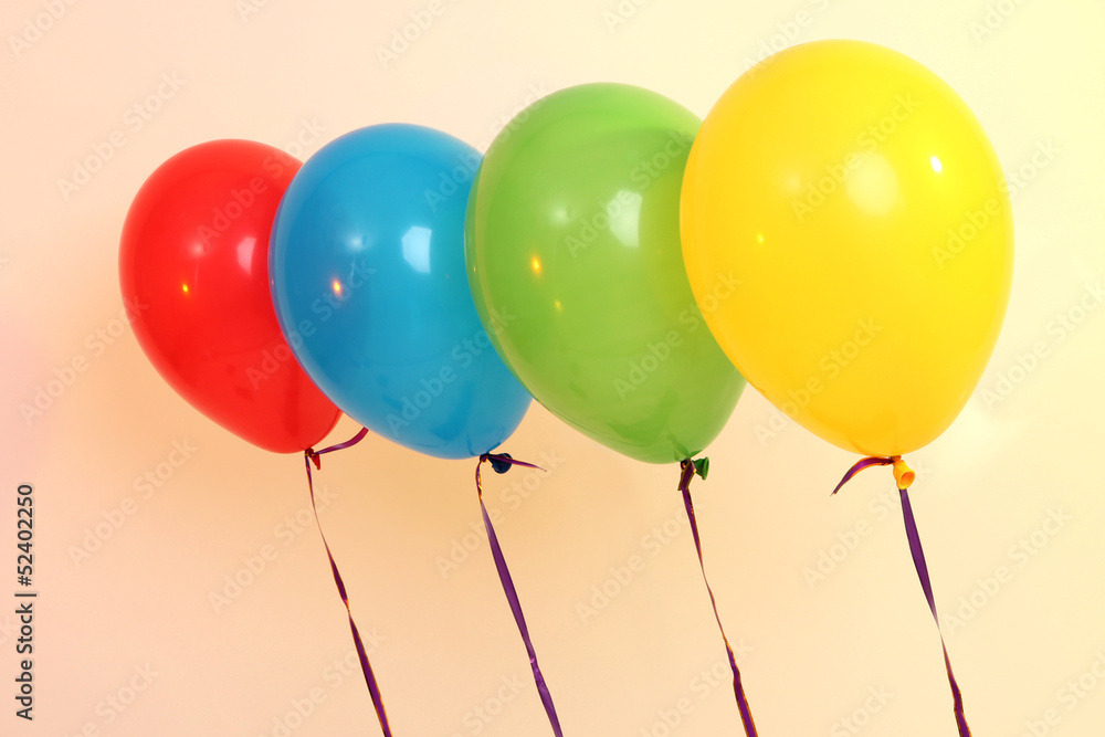 Four bright balloons on light background