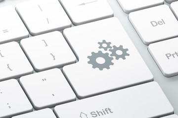 Data concept: Gears on computer keyboard background