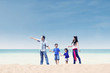 © Creativa Images - Asian family enjoy holiday at beach