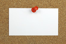Push Pin Holding A Blank Note Card On A Cork Board