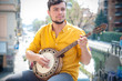 © Eugenio Marongiu - hipster young man playing banjo