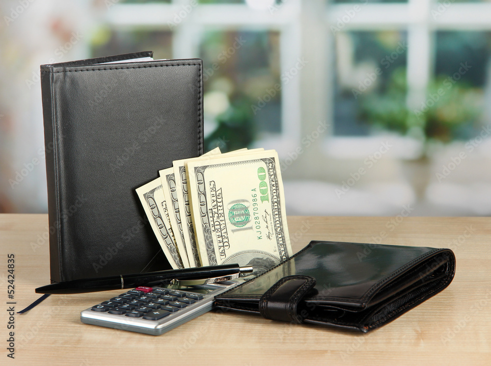 Set of business accessories on wooden table on window