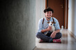 © Eugenio Marongiu - Portrait of smiling young man cuddling Jack Russell Terrier while sitting on floor