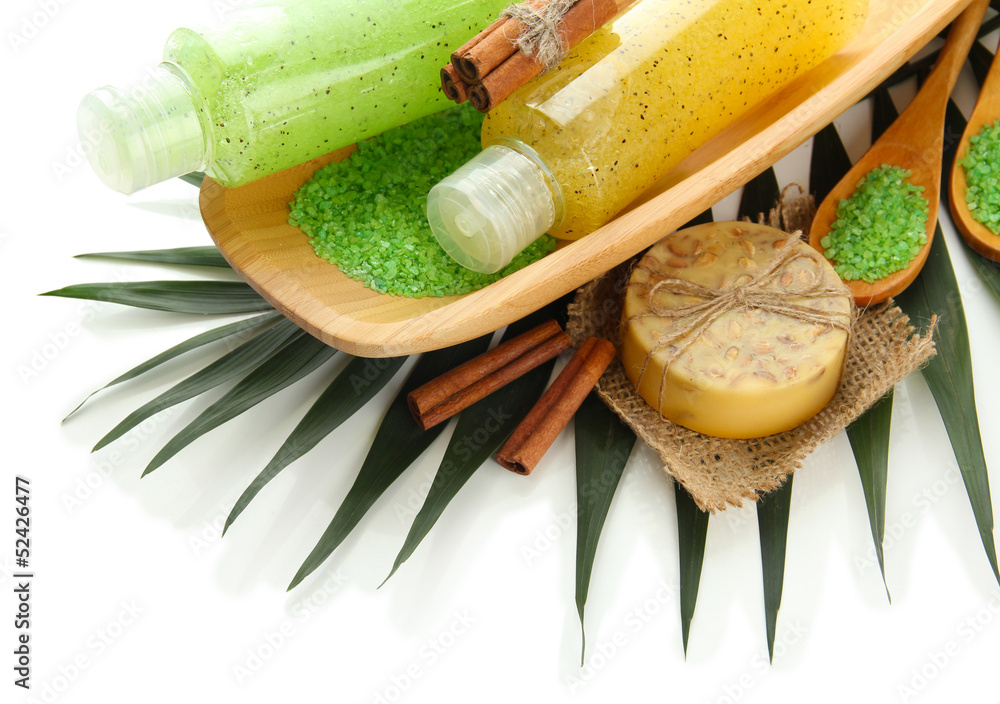 Bottles with scrub and hand-made soap, isolated on white