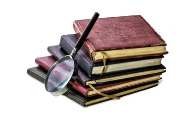 books and magnifying glass. on white background
