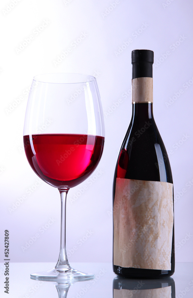 Glass of wine with bottle isolated on white