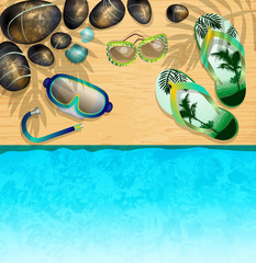 Flip-flops, Mask for Diving, sunglasses and stones on the beach