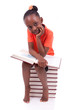 Cute black african american little girl reading a book - African
