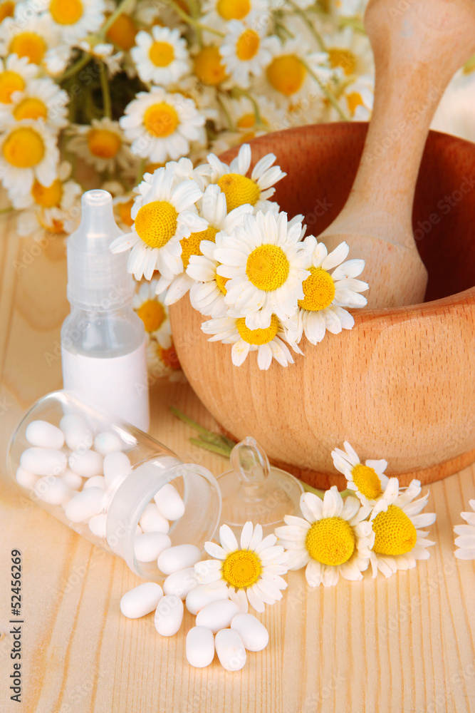 Medicine chamomile flowers on wooden table