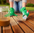 Applying protective varnish on a patio wooden floor