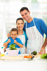 beautiful young family cooking at home