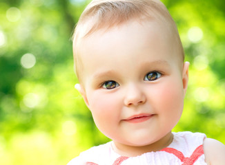 Little Baby Girl Portrait outdoor. Child over nature background