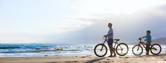 Wall Mural - Mother and son biking at beach