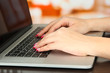 © Africa Studio - Female hands typing on laptop, on bright background