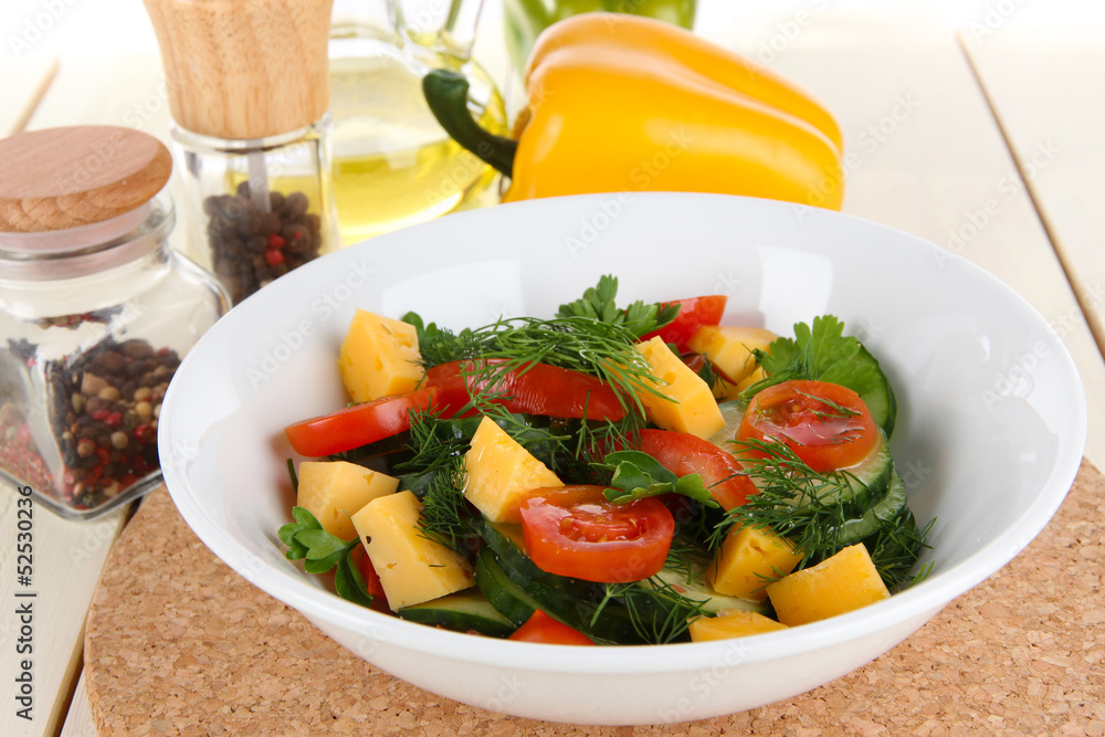 Light salad in plate on wooden table