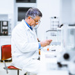 © lightpoet - Senior male researcher carrying out scientific research in a lab