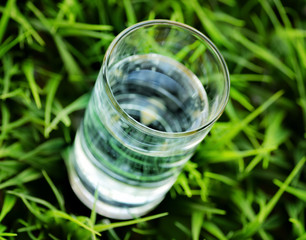 Sticker - Glass of water on nature background