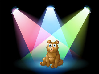 Wall Mural - A bear sitting at the center of the stage with spotlights