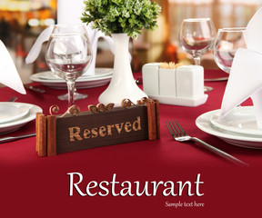 Sticker - Reserved sign on restaurant table with empty dishes and glasses