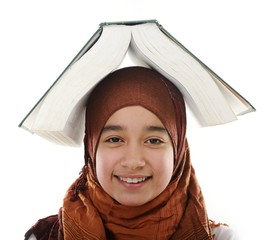 Female Arabic student balancing big book on head