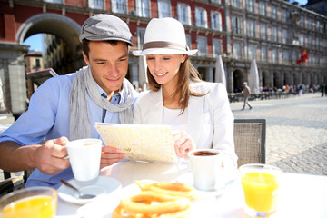 Tourists looking at city map in Spanish restaurant