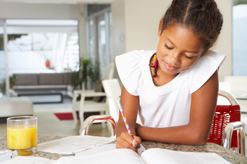 Girl Doing Homework In Kitchen