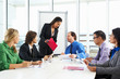© Monkey Business - Businesswoman Conducting Meeting In Boardroom