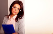 © Drobot Dean - Young beautiful businesswoman in office holding a folder