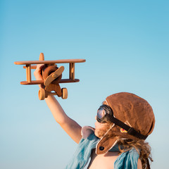 Canvas Print - Happy kid playing with toy airplane