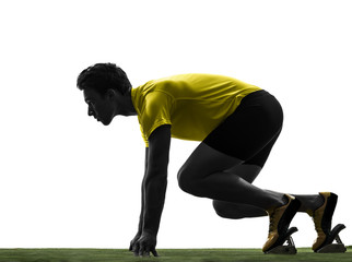 Wall Mural - young man sprinter runner in starting blocks silhouette