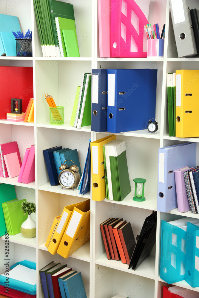 White office shelves with different stationery, close up