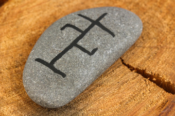 Fortune telling  with symbols on stone on wooden background