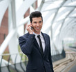 © mimagephotos - Businessman smiling and talking on the phone