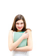 © stormy - Teenage girl holding book and looking happy on white