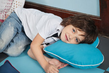 Boy Lying On Heartshaped Pillow In